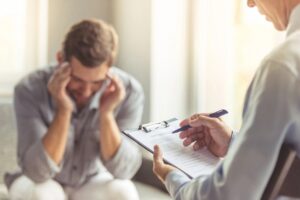 Person speaking with a counselor about emotional distress and recovery